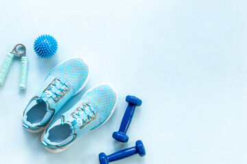 Sports equipment flat lay. Sneakers and dumbbells for fitness