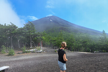 woman with a view on the summit of mount fuji from the fifth station