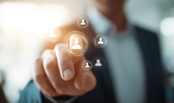 Man interacts with a digital interface to manage team members virtually.