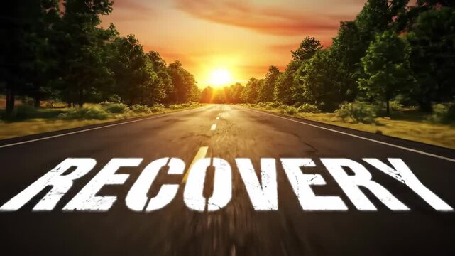 A asphalt road with text recovery ahead with sunlight. Represent the journey and future towards recovery on the road with trees at sunset