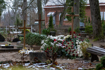 Winter Cemetery Scene with Wooden Crosses and Fresh Funeral Flowers