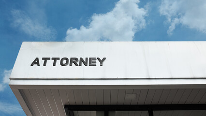 Attorney word sign displayed on building under clear blue sky, representing legal services, law practice, justice, and professional consultation