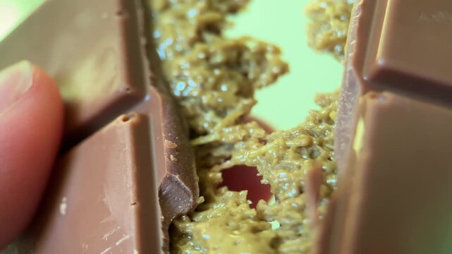 Dubai chocolate close-up macro, chocolate bar breaking, sweets with filling, kataifi dough and pistachio paste