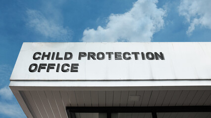 Obraz premium Child Protection Office word sign displayed on a building under a clear blue sky, representing child welfare, social services, safety, advocacy, and government facilities