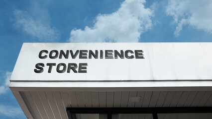Convenience Store word sign displayed on a building under a clear blue sky, representing retail, shopping, quick service, daily essentials, and urban commercial facilities