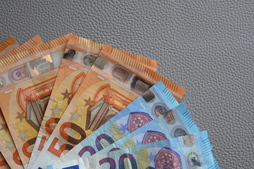 Black partmone with euro money. Paper bills in leather wallet for commerce concept.