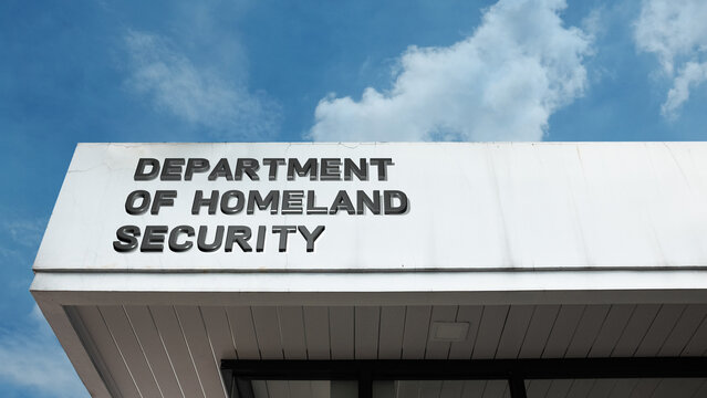 Department of Homeland Security word sign on a building under a clear blue sky, symbolizing national security, government policy, protection, and emergency services