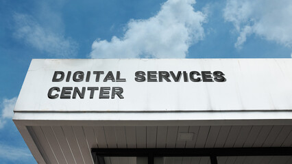 Digital Services Center word sign displayed on a building under a clear blue sky, representing technology, digital solutions, services, and IT support.