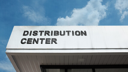 Distribution Center word sign displayed on a building under a clear blue sky, symbolizing logistics, warehousing, storage, and the movement of goods and products