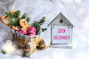 Calendar for December 29: the number 29 and the month name "December" in English on a decorative calendar next to a sleigh