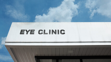 Eye Clinic sign displayed on a building against a clear blue sky, symbolizing specialized healthcare, vision correction, ophthalmology services, medical treatment, and optical care.