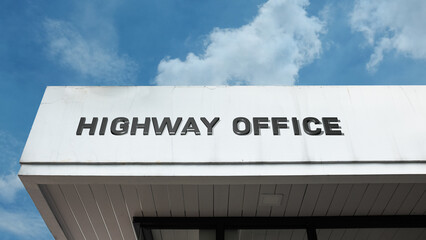Highway Office sign displayed on a building against a clear blue sky, symbolizing road management, transportation administration, infrastructure, and control
