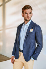 A grayscale portrait of a man in a blazer, creating a dramatic and artistic feel with strong contrast and expressive styling.