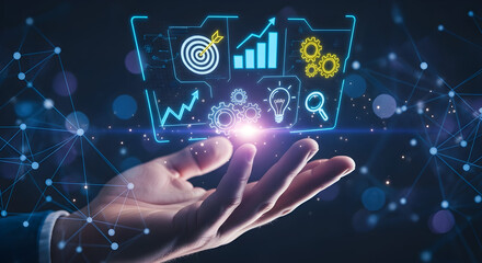 Hand holding futuristic holographic interface with business analytics icons.
