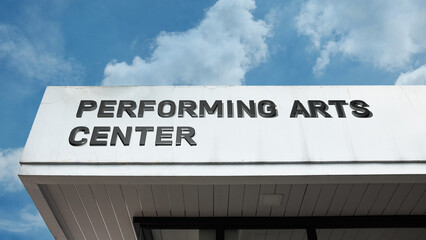 Performing Arts Center word signage on a grand cultural building under a blue sky, symbolizing theater, music, culture, and entertainment venue