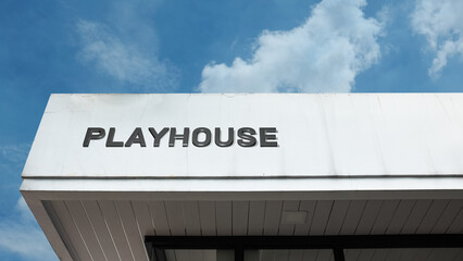 Playhouse word signage on a children's or theater building under a blue sky, symbolizing entertainment, arts, education, recreation, and creative leisure