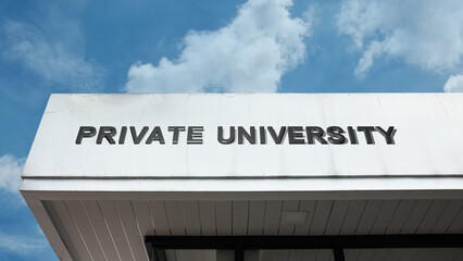 Obraz premium Private University word signage on a higher education building under a blue sky, symbolizing academic excellence, tuition, exclusive learning, and research