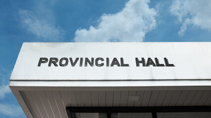 Obraz premium Provincial Hall word signage on a government building under a blue sky, symbolizing regional administration, local authority, political governance, and public service