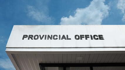 Obraz premium Provincial Office word signage on a government building under a blue sky, symbolizing regional administration, local authority, political management, and public service location