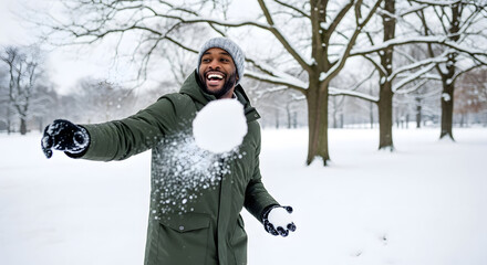 Joyful Winter Play: A man is captured mid-throw, a snowball in motion, as he engages in a lighthearted snowball fight amidst a snowy landscape. the joy of winter games.