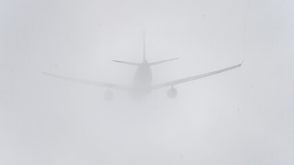 The aircraft was in a cloud of mist on the runway. the plane in the fog on the Runway. High quality photo