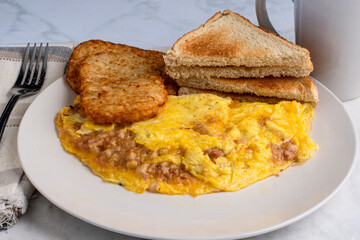 corn beef hash omelette with hash browns and toast