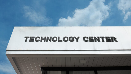 Technology Center word signage on a modern corporate or research building under a blue sky, symbolizing innovation, digital hub, science, computing, development, engineering, future progress