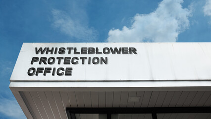 Whistleblower Protection Office word signage on a government building under a blue sky, symbolizing integrity, security, ethics, reporting, and anti-corruption