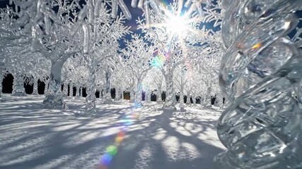 A close up view of ice covered trees in a winter landscape with bright sunlight shining