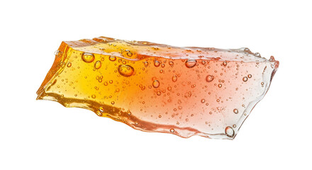 Translucent amber candy bark with trapped air bubbles isolated against a white backdrop offering a textured and colorful treat