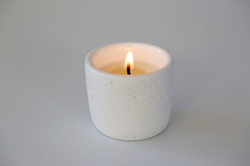White ceramic scented candle burning