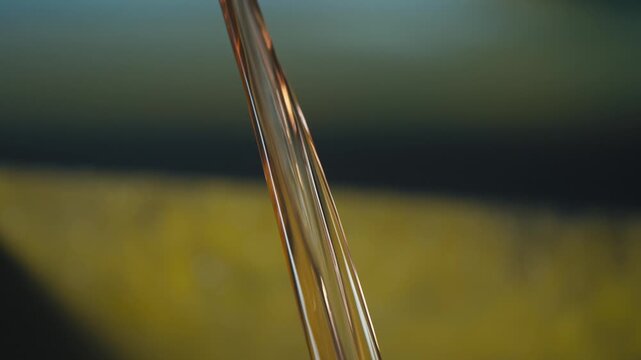 Close-Up of Clear Engine Oil Flowing Into Drain Pan