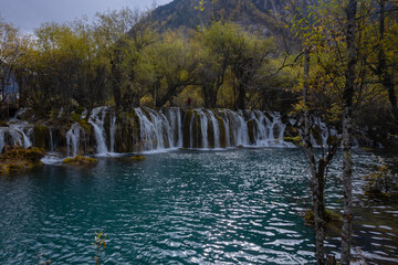 The  Arrow Bamboo Lake Waterfall in Jiuzhaigou National Park is a famous tourist attraction in Sichuan, especially during the autumn leaves season, China