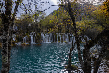 The  Arrow Bamboo Lake Waterfall in Jiuzhaigou National Park is a famous tourist attraction in Sichuan, especially during the autumn leaves season, China