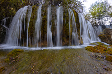 The  Arrow Bamboo Lake Waterfall in Jiuzhaigou National Park is a famous tourist attraction in Sichuan, especially during the autumn leaves season, China