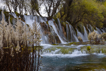 The  Arrow Bamboo Lake Waterfall in Jiuzhaigou National Park is a famous tourist attraction in Sichuan, especially during the autumn leaves season, China