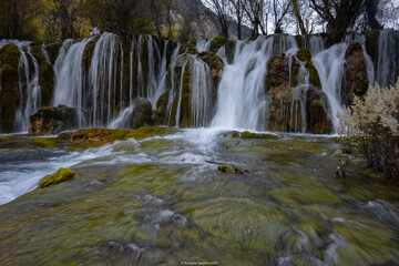 The  Arrow Bamboo Lake Waterfall in Jiuzhaigou National Park is a famous tourist attraction in Sichuan, especially during the autumn leaves season, China