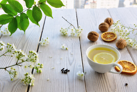 A cup of tea with lemon and mint on a tableA cup of tea with lemon and mint on a table