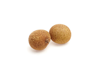 Fototapeta premium Longan tropical fruit, featuring two round, textured brown fruits with a smooth surface, showcasing natural beauty and freshness in a minimalist setting for culinary and health concepts