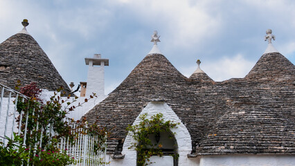 Traditional trulli houses.  Conical roofs made of stone slabs. Alberobello, province of Bari, Puglia region, Italy