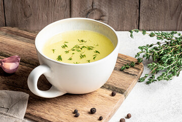 Hot healing bouillon (chicken bone broth) with herbs