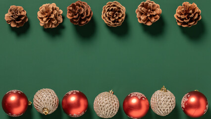 christmas decoration and pine cones on a green background,hristmas decoration and pine cones frame with copy space,Green Christmas background	with christmas ball and pine cones
