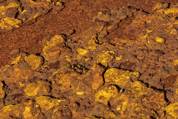 Close-up of weathered rust texture with peeling layers and warm orange patina, detailed industrial surface background