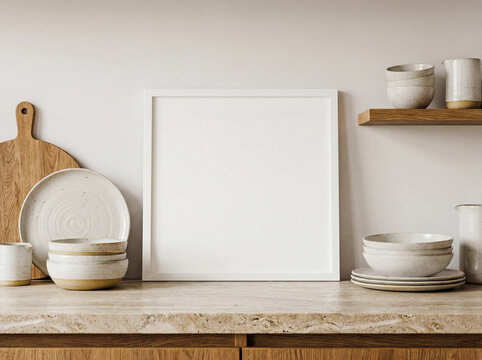 Blank white square poster frame mockup in modern kitchen interior stone counter shelf ceramics cooking culinary concept front view flat lighting high resolution home design background copy space art 