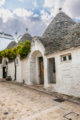 Traditional trulli houses. Street view. Alberobello, province of Bari, Puglia region, Italy