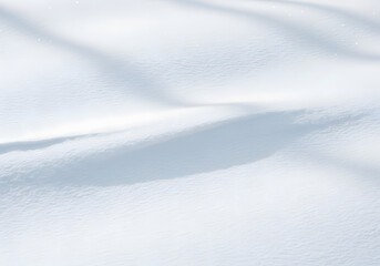 Obraz premium Blanket of Fresh Snow A Serene Close-Up of Snowdrift Textures and Shadows on a Winter Day