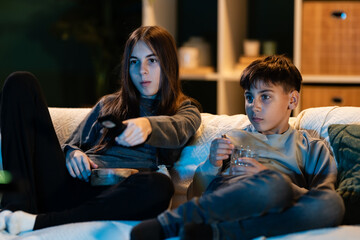 Fototapeta premium Siblings enjoying movie night watching television
