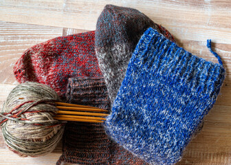 colorful knitting yarn and knitting needles, knitwear fashion, wool socks and needles, knitting hobby, handcraft clothing, handcraft concept