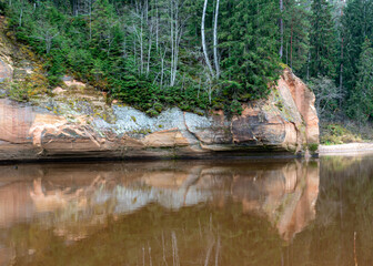 beautiful view of sandstone outcrops on the riverbank, autumn landscape, reflections in the river