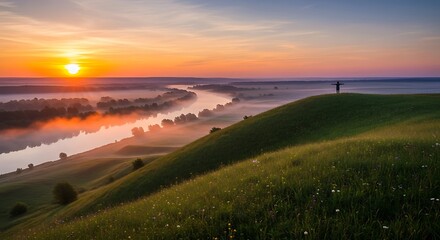 Sunrise over misty river valley and hill